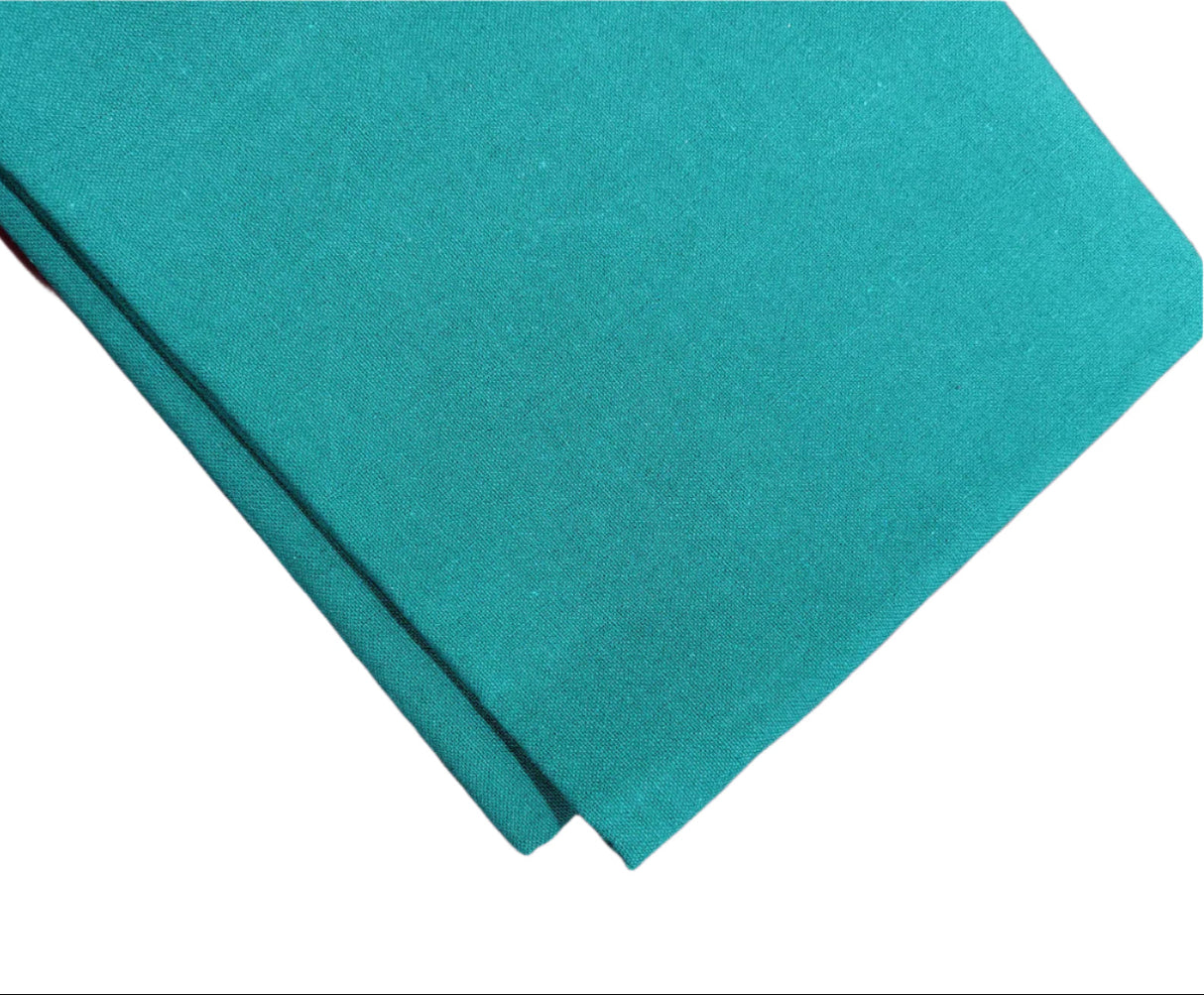 Casement embroidery fabric in teal green color, placed on white background, as viewed from top