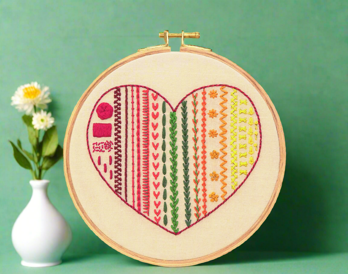 Embroidery hoop art with heart shape design, multiple stitches. modern embroidery pattern in colorful vibrant embroidery stiches placed on dark red background