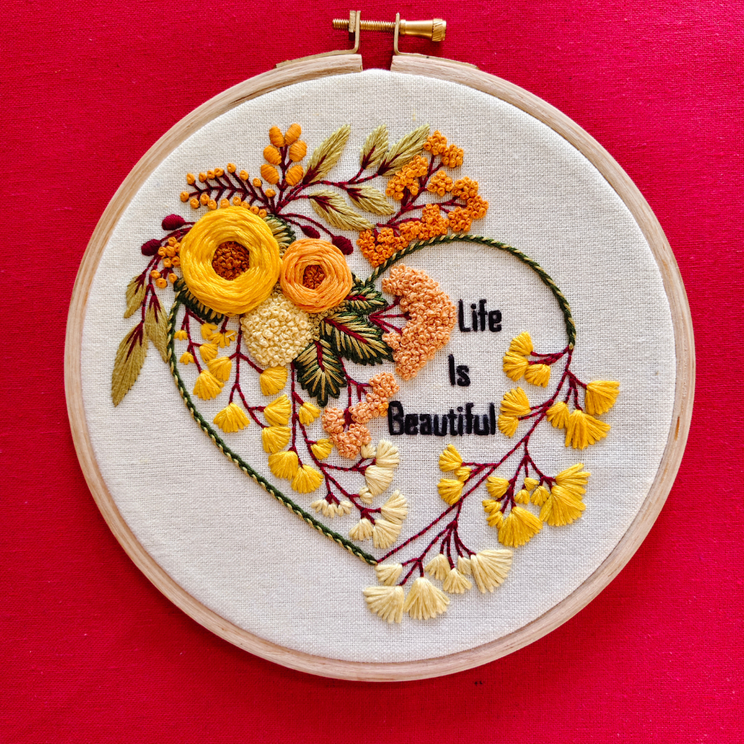 Beautiful, Super Creative Embroidery Hoop Art with amazing yellow, orange and beige flowers with life is beautiful, stitched lettering in black color thread